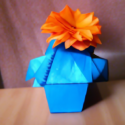 A blue vase holding orange origami flowers (failure case)